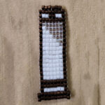 Guillotine made from bronze brown, white, and silver beads
