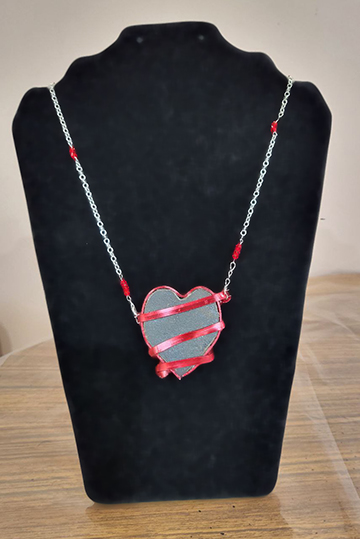 necklace with a heart-shaped rock, wrapped in wire, and matching crystals on the chain